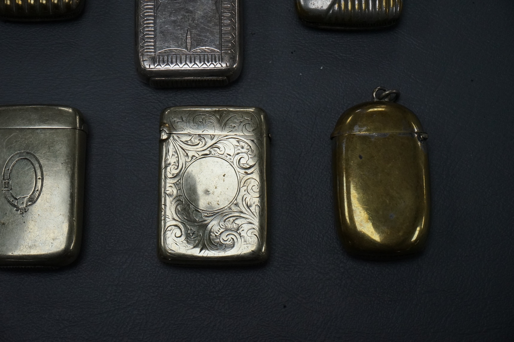 Seven base metal vesta cases, largest 6cm high